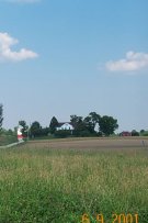on the right side of the road across from the site