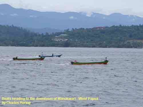 Boats heading to downtown Manokwari - West Papua. The photo was shot by Charles Roring