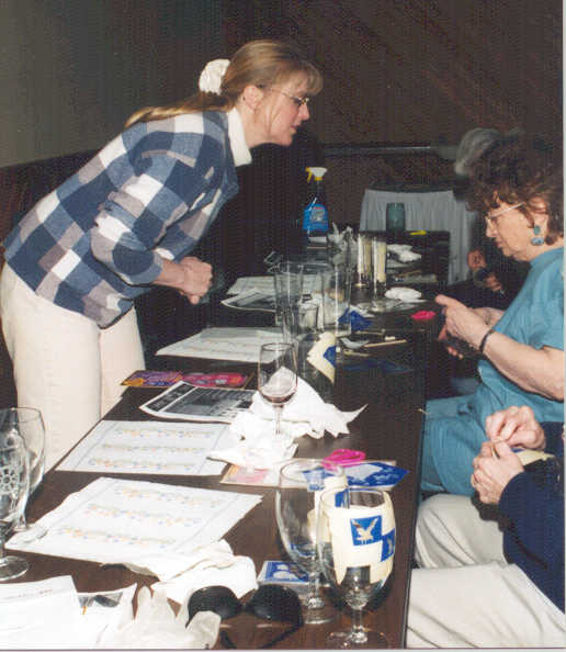 Photo of an auxiliarist teaching glass etching at a spring conference.