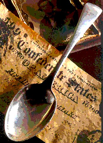 picture of spoon laying on Confederate note with a daguerreotype in the background