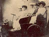 people in an old fashioned car