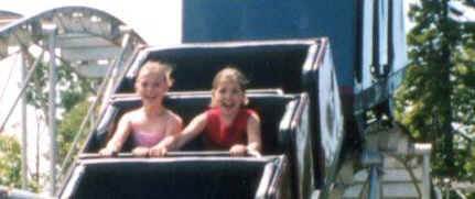 Ainsley and Sarah on the roller coaster, Chippewa park, July 2003