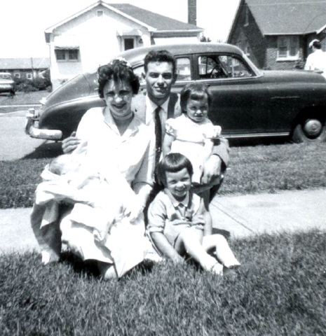 Our son Rob's christening June 1962 with Carolyn(standing)2 years old and Donna (sitting)3 1/2 years old.The old 1950 Pontiac (background) was our wheels in those years.