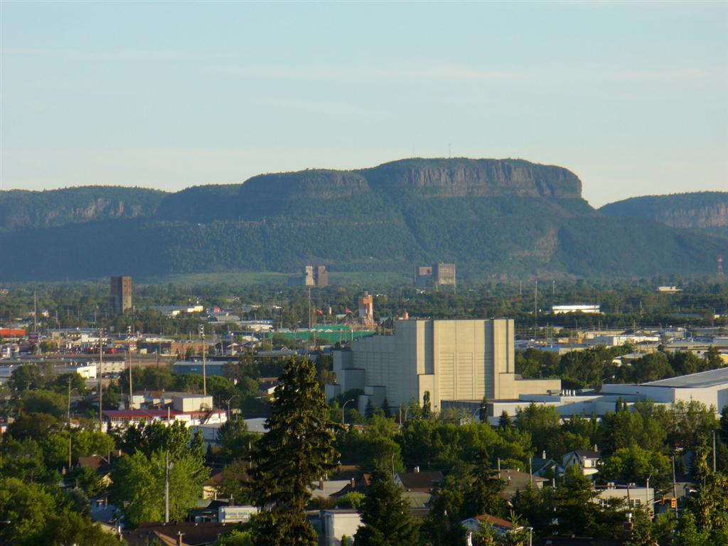 view from Hillcrest park looking south toward intercity area , with Mt. McKay in the distance, Community Auditorium is center foreground,with Canada Games Complex to the right