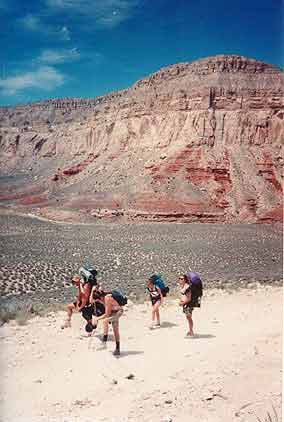 Hikers pause, exhauted from the hike out of the canyon.  They approach the most difficult leg of the hike: a mile of switchbacks scaling 2000 feet up the cliffs.