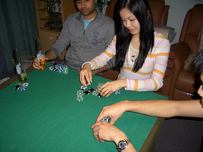 May neatly stacking up chips freshly won from Mark