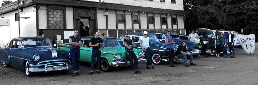 The Pittsburgh Drifters CC standing with their ratrod , custome ,  hotrods.
