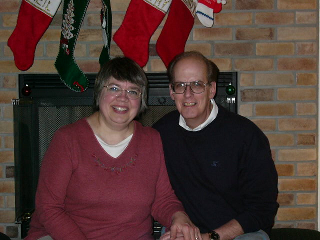 Kathy and Neil sitting by the fireplace.