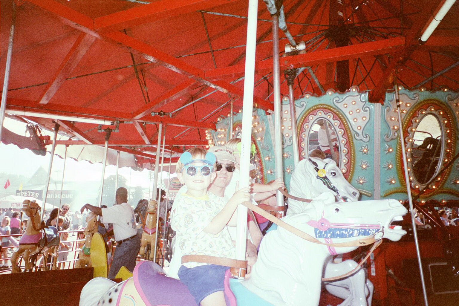 Rick, Kyler and Taran riding the Carousel.