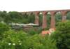 anorthyorkshiremoorsrailwaystrainsteamsundertheviaducttowardswhitby_small.jpg