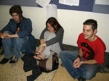 Some guy, Kristin, and Xandon sitting on the ground level of the Drake Union