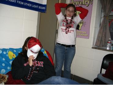 Jill covering her face and Renee coming out of the bathroom
