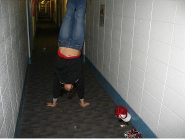 Jill doing a handstand in the hall