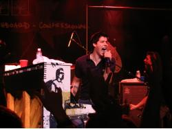 Andrew singing by his piano