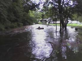 Teenager floating and inner tube down the stream during minor flooding of June 26, 2006