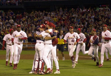 Cards players rush the field after clinching home field advantage