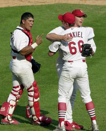 Hernandez, Ankiel, and Veres celebrate the game one win