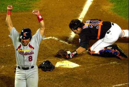 Hernandez beats out Piaza's catch to score in the 3rd game win.