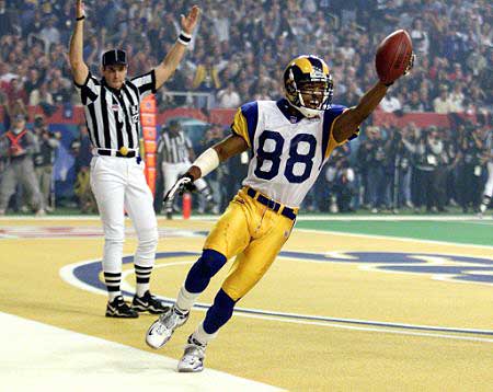 Torry Holt lofts the ball in the end zone