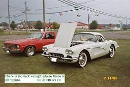 Red car and a vintage white Corvette.