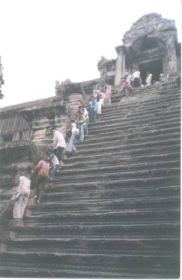 It is a steep climb up to the central tower of ANGKOR WAT.&nbsp; A handrail has been installed for tourists.&nbsp; The steps are worn, broken, and curved upward from time...
