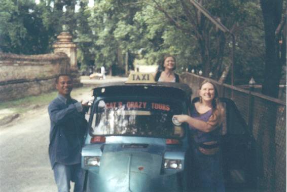 Cat, Tara, Judith with Cat's tuk-tuk, a three wheeler.
