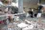 Flattened car under debries of building after earthquake at Yogyaarta
