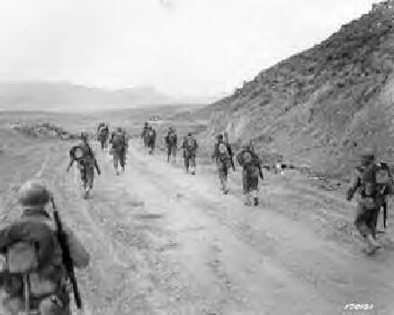 The 2nd Battalion, 16th Infantry, march through the Kasserine Pass and on to Kasserine and Farriana, Tunisia. 26 Feb 1943.