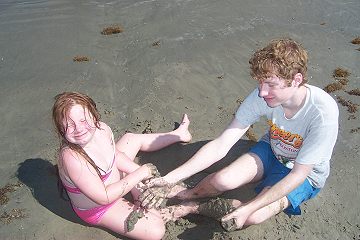 Big brother picking on little sister but she's still smiling.