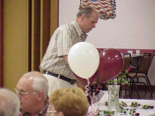 Al Asiello presenting a rose in memory of a deceased classmate