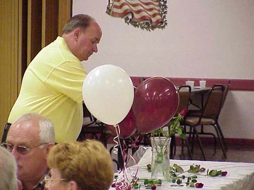 Coley Harrington presenting rose in memory of a deceased classmate