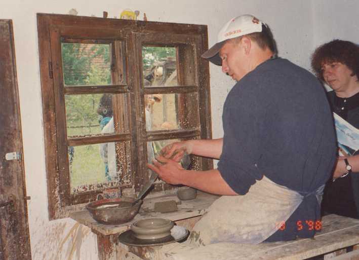 Potter at his wheel with our coordinator Judith Szirmai watching.