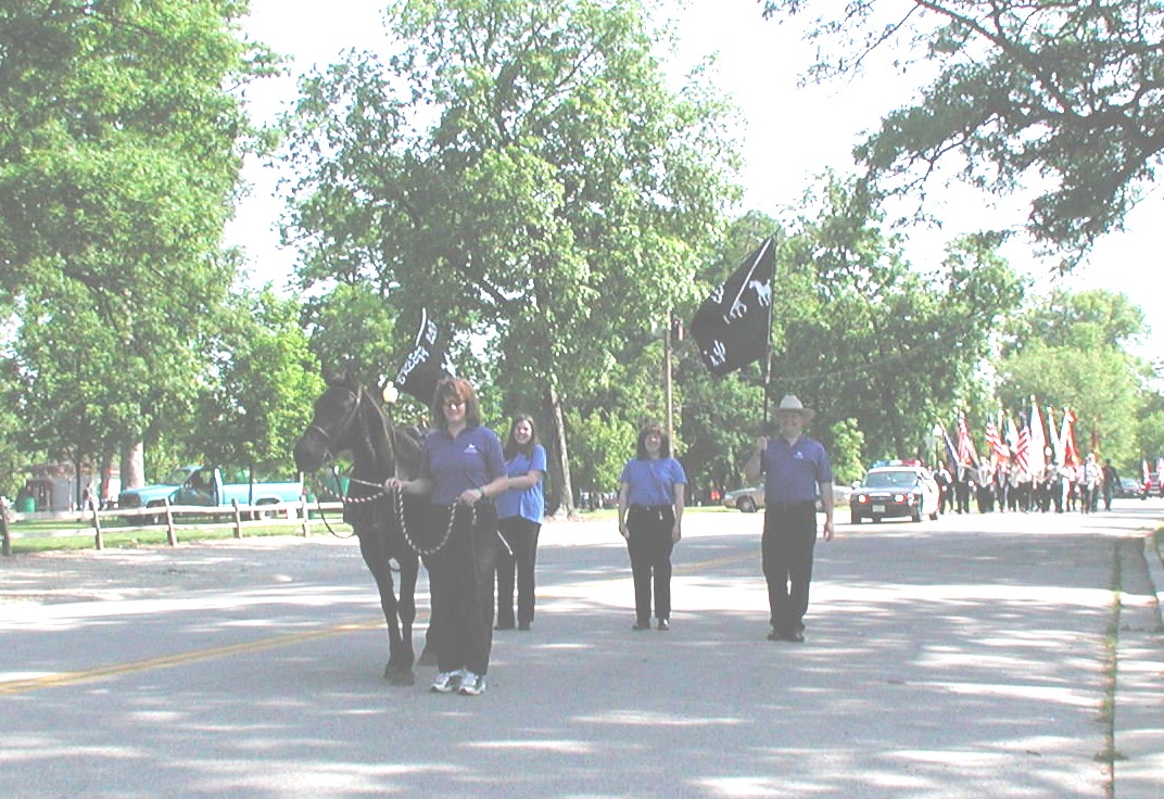 Kim leads Oprah in a Memorial Day Parade in Bloomington