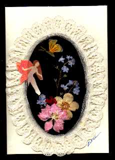 forget me nots, pink larkspur, potentilla that has turned cream from yellow, buttefly is made out of pansy petals