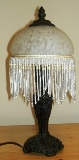 12. Victorian-style lamp with glass and bead shade.
