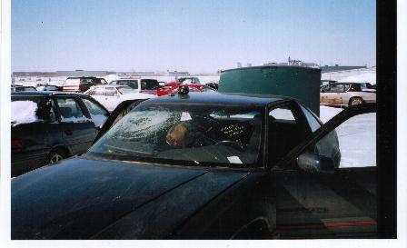 view from front. Passenger airbag hit the front windshield being forced up when the door caved in. Friend Bob checking out the inside.