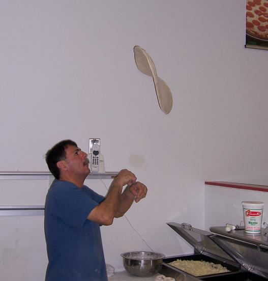 Pizza being tossed