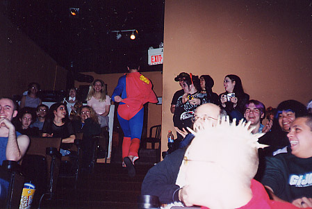 His ass, that is.  Not that he's an ass.  He isn't.  It's just his ass is in the shot, ya know.  And I guess he isn't really wearing a mask...  But he parts his hair on the other side.  Or something.  Look, I'm just gonna move right along, 'kay?