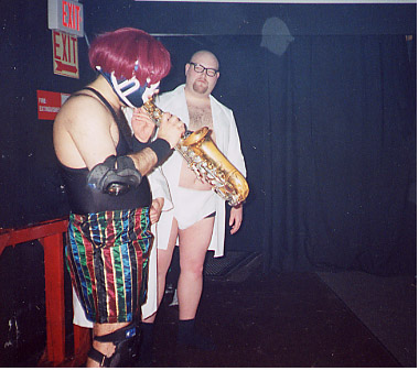 Larry seems critical of Burrito's innovative mouthpiece-less sax technique.  Philistine.