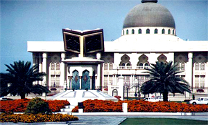 Emir palace behind square with an open Koran monument.