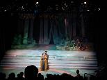 Oberon tries to woo an angry Titania in the woods.