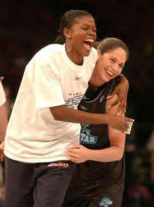 Sheryl Swoopes hugs Sue Bird after Bird sunk a basket from half court.