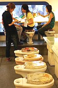 Customers place their orders from a row of toilets at Marton, Taiwan's most recent hit theme restaurant. The restaurant's toilet theme has become so popular serving light meals and ice-cream treats in western and Asian style toilets, the owner Eric Wang, 26, has opened a second branch just seven months after the first.