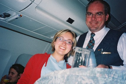 Kelsy helping serve orange juice on the plane