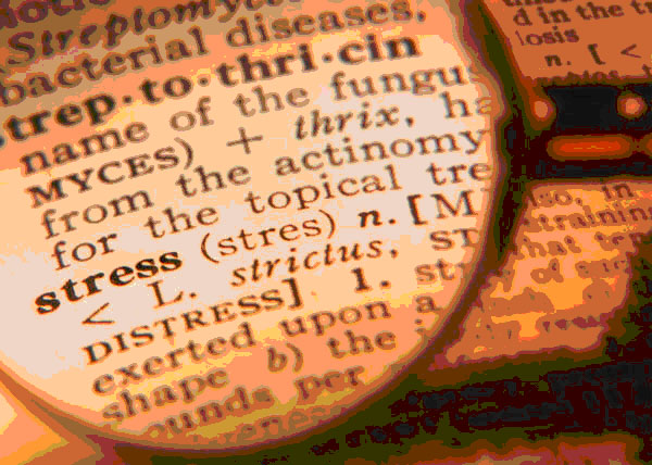 magnifying glass on dictionary enlarging the word stress