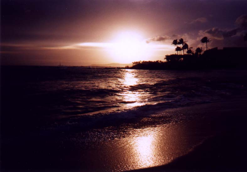 large photo of amber,
black,
and violet sunset with really cool lens flare taken at Poipu Beach