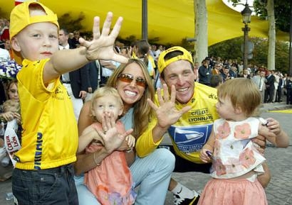Five-time Tour de France winner Lance Armstrong of Austin, Texas, his wife Kristin, son Luke and twin daughters Isabella Rose and Grace Elizabeth signal five, after the final stage of the 2003 Tour de France in Paris on July 27, 2003. Armstrong and his wife have separated and are planning to divorce, a spokesman for his cycling team said Thursday, Sept. 4, 2003. (AP Photo/Michel Spingler, File)