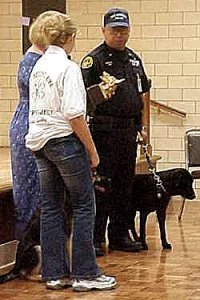 Officer Lim and his K-9 Sprig
receiving a statue of Buddy, 
the 1st Seeing Eye Dog