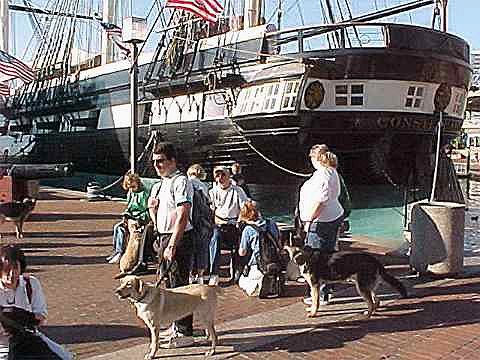Pups and Puppy Raisers prepare to 
board the USS Constellation