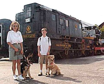 Diane, Sirius, another Puppy Raiser and a classmate
by one of the many different trains on the outside grounds